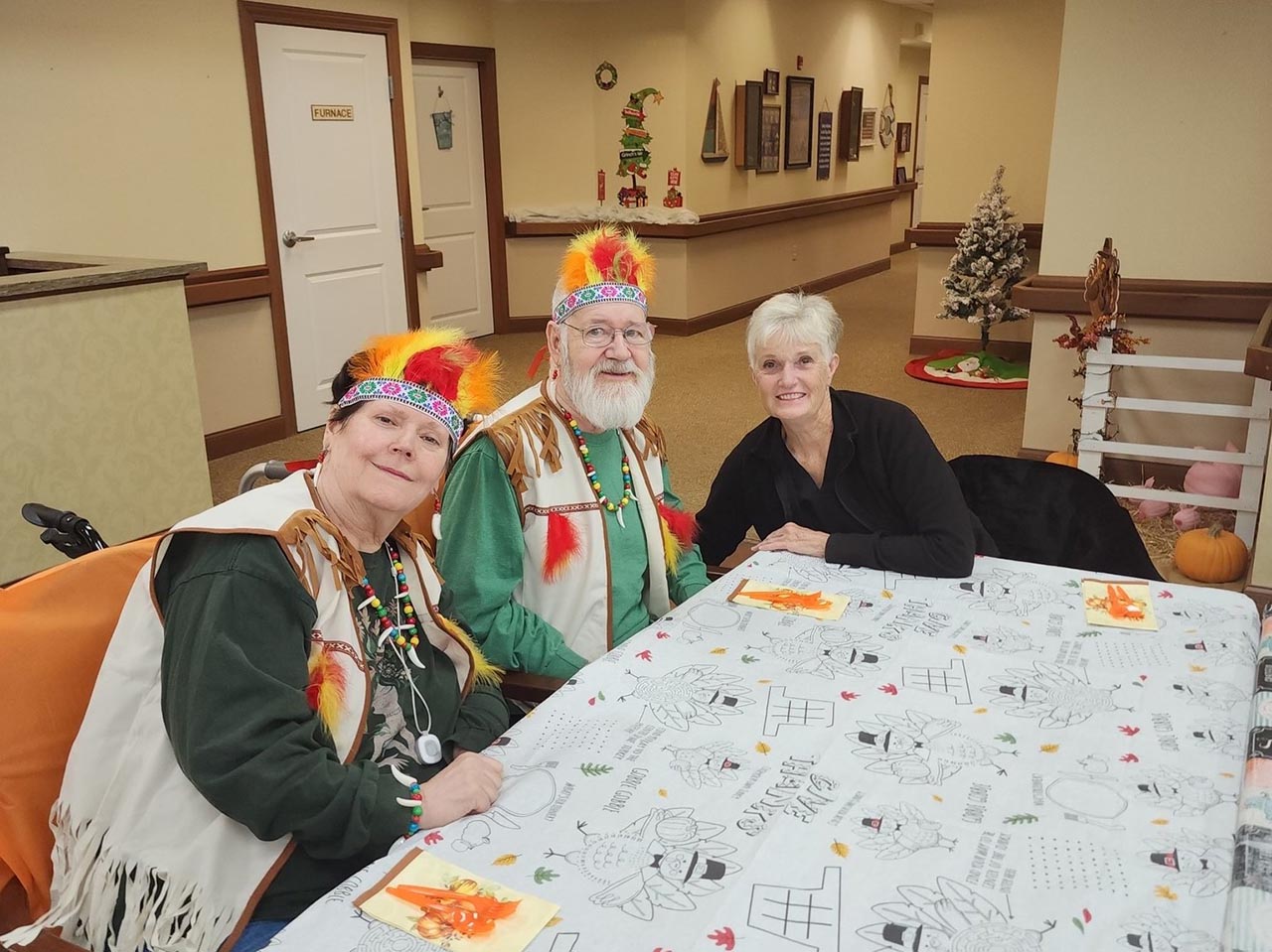 staff member and residents celebrating Thanksgiving