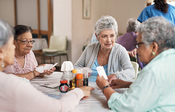 Shot of a group of senior women playing cards together at a retirement home